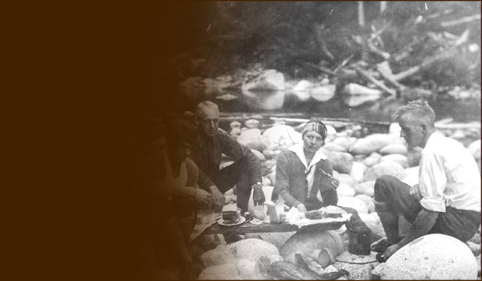 Climbers' riverside meal atop boulders. Photo BCMC Archives 39-325.