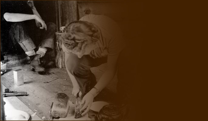 Woman slicing loaf for hikers' tea. Photo NVMA 1110-9.