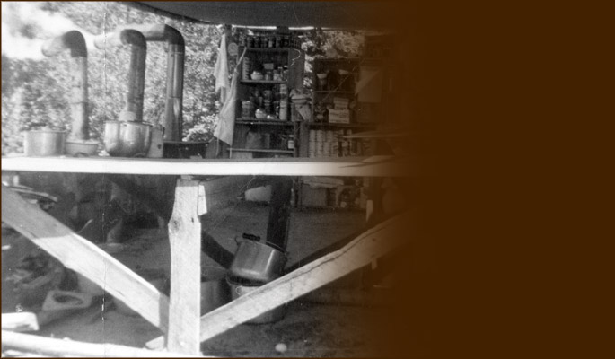 Tarp-covered outdoor kitchen. Photo BCMC Archives 42-3.