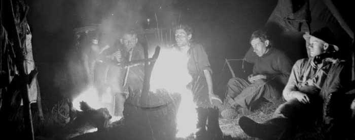 Around campfire. Chapman Collection, BCMC 61-101.