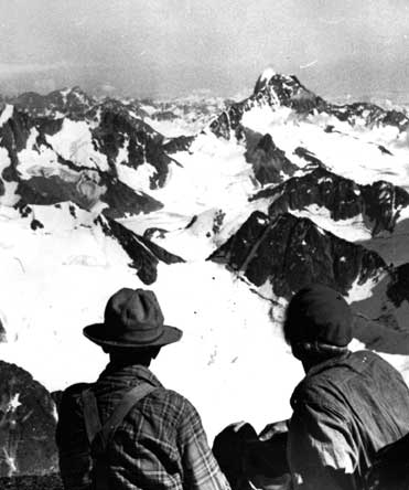 Don and Phyl Munday look from Reliance summit. Photo Royal BC Museum, BC Archives.  H03441.