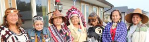 Seven women dressed in regalia on porch. 2016 North Vancouver