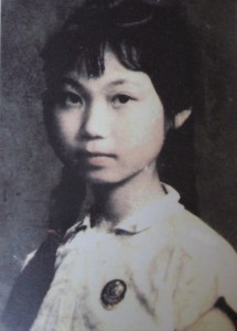 Portrait of a young girl, with a button in honour of Mao Zedong pinned to her chest.