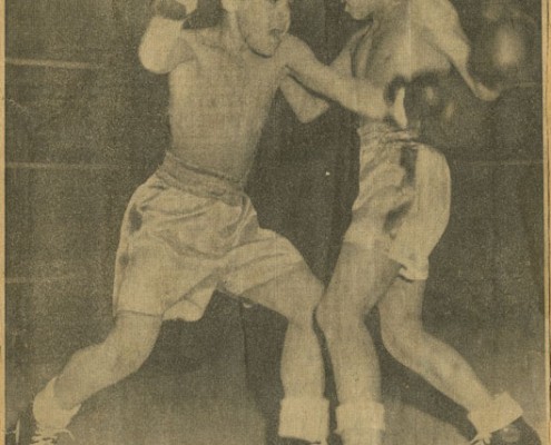 Newspaper clipping showing two aboriginal boys boxing.