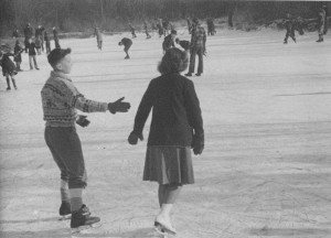 Yvonne skating with a boy at an outdoor rink.