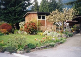 Colour photograph of a house and manicured yard.