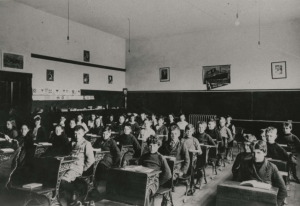Pupils in Lynn Valley School class room. Vera Fromme, third from left. Alec Allan, first row at right. NVMA 6983