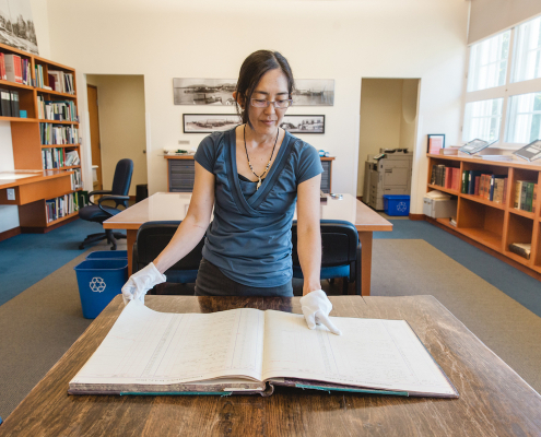 Reference Historian Daien Ide supports research and exploration of North Vancouver and its people through archival collections, research and exhibits. Public access to the Archives’ Reading Room is currently by appointment only. Photo: Alison Boulier
