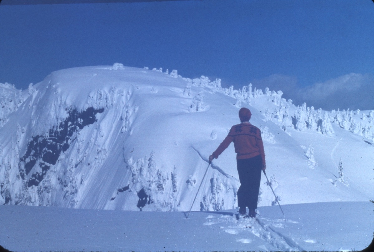 Joyce Coats looks towards one of Mount Seymour's peaks during a ski tour, 1956. Photo: GJC 56-12