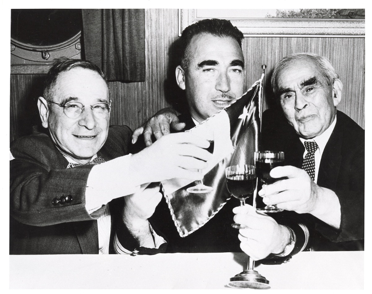 Chilean Consul H.G. Morris (left), Capt. Vargas (centre) and Manuel Silva (right) celebrating Chilean Independence Day, 18 September 1953. NVMA 6364.