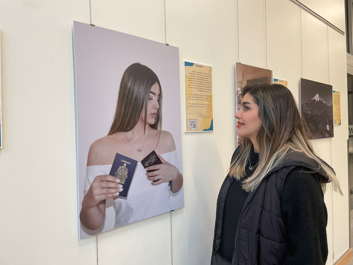 Mahshid Rezaei next to her submission in the 'Voices of Diversity: North Vancouver's Newcomers' exhibit, 20 February 2023.